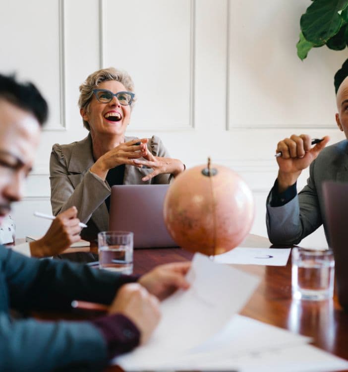 A group of people sitting around a table.