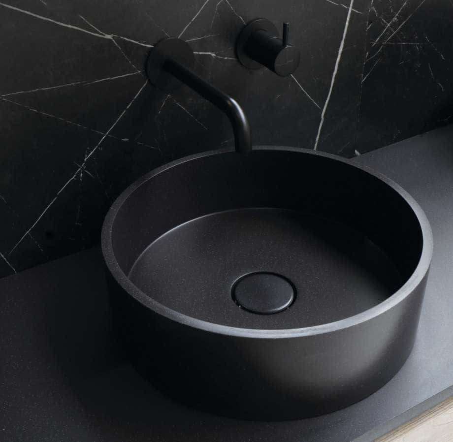 A black sink sitting on top of a counter.